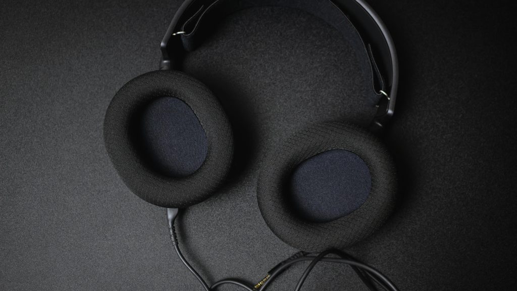 Black over-ear headphones with a detachable cable, ideal for gaming and music enthusiasts.